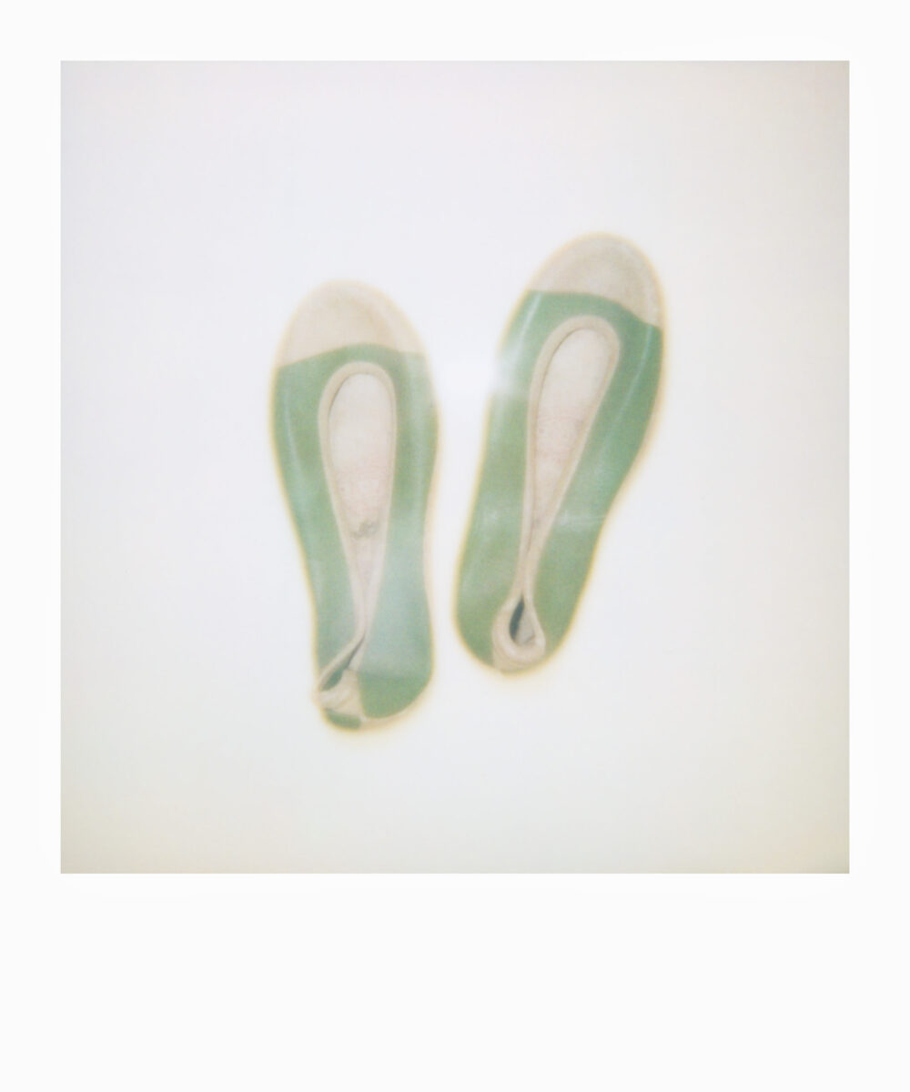 oversized Polaroid of a pair of green Korean rubber shoes