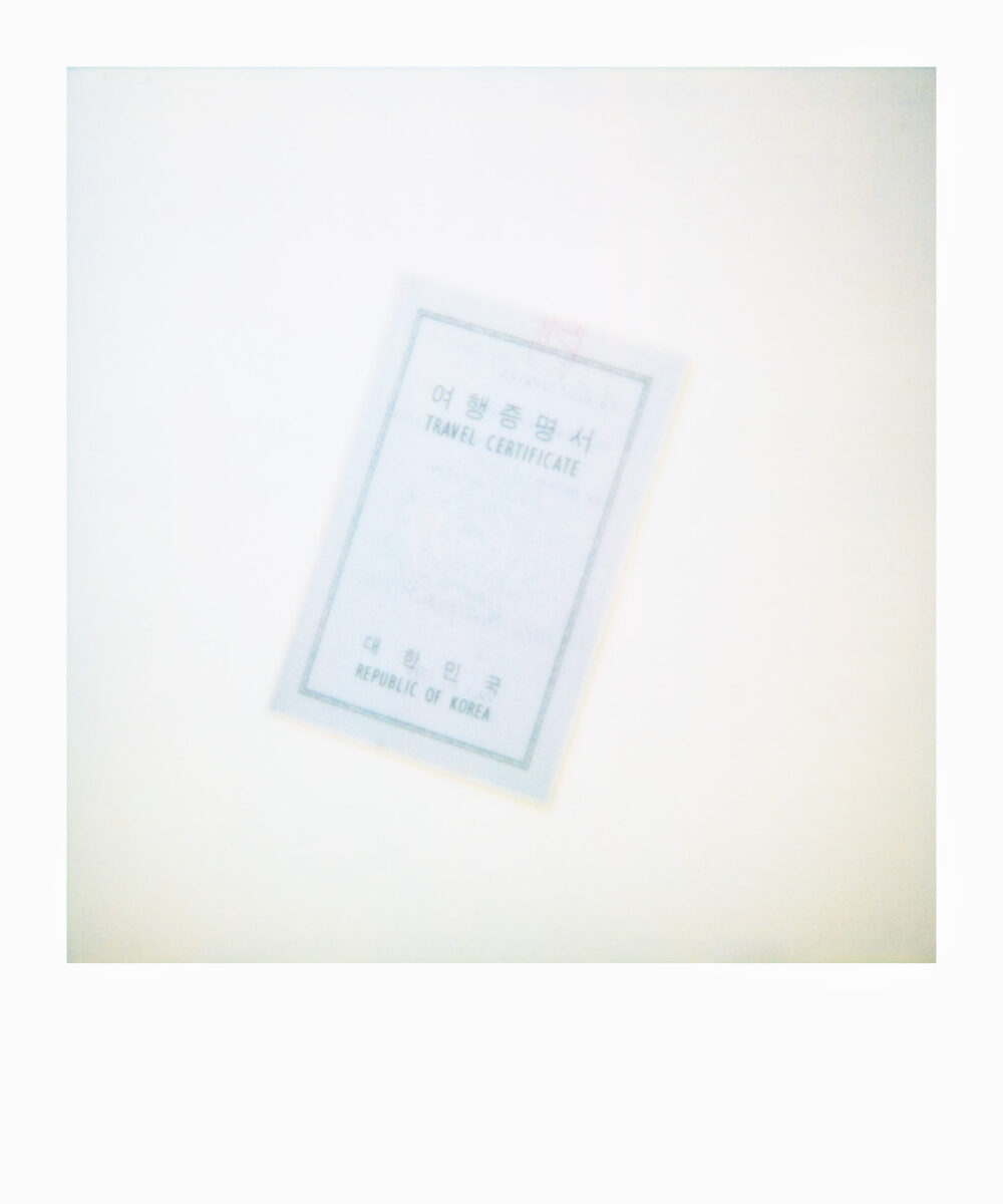oversized Polaroid of a Korean travel certificate from the 1970s